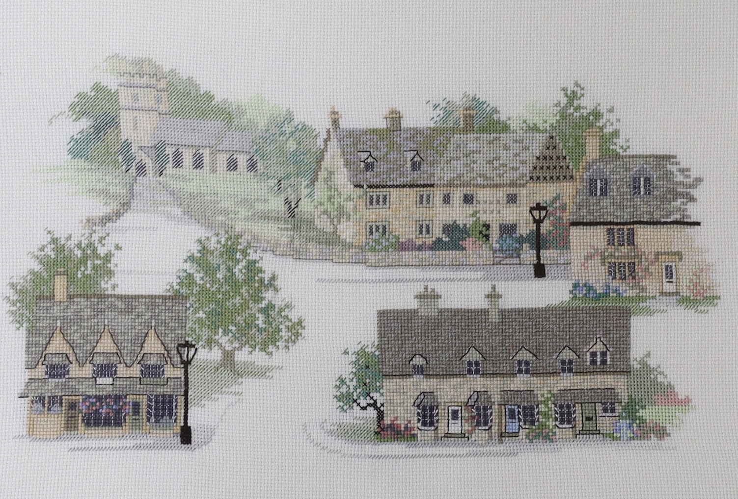 Five various pictures including a pastel and watercolour by Yvonne Wemyss, Still life of flowers, together with an embroidery of Cotswold Villages, largest 42 x 26cm